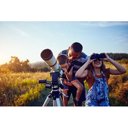 Father and Kids Looking at Night Sky with Telescope