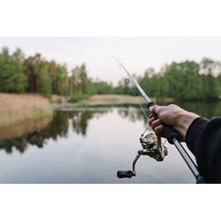 Fisherman with Spinning Reel on Fishing Rod